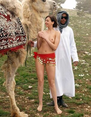Tiny little nymph posing near camel